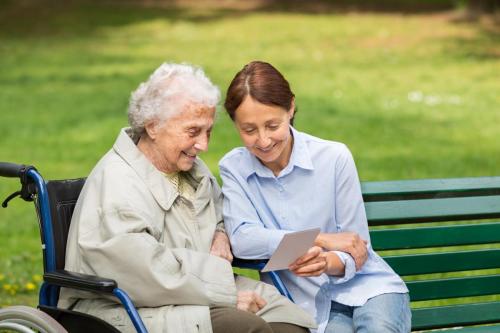 Photo of a caretaker and person in wheelchair